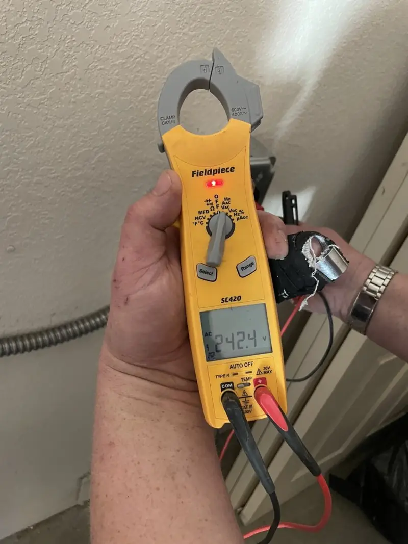 Voltage testing with clamp meter during Ceiling Fan Installation in Martic